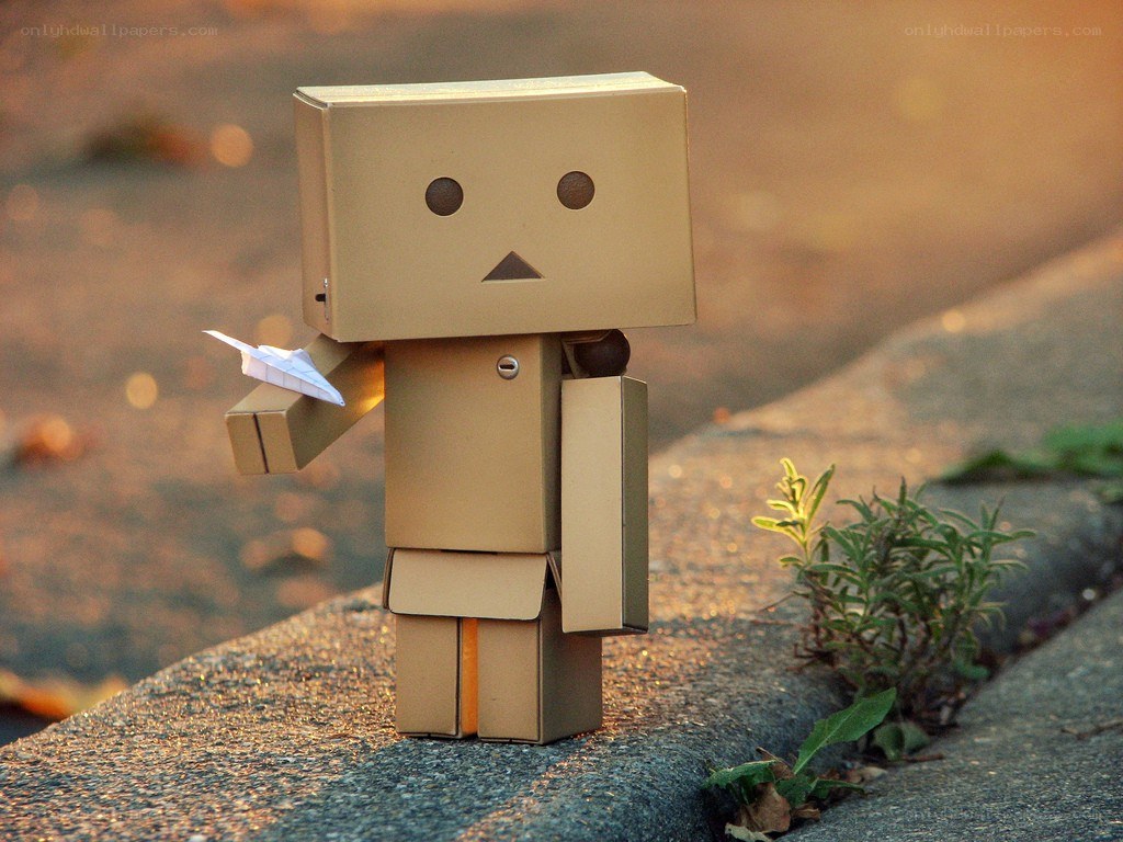 cardboard robot with paper airplane