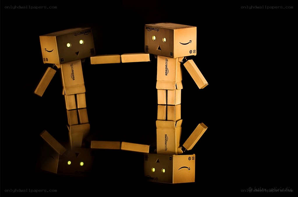Cardboard robots holding hands