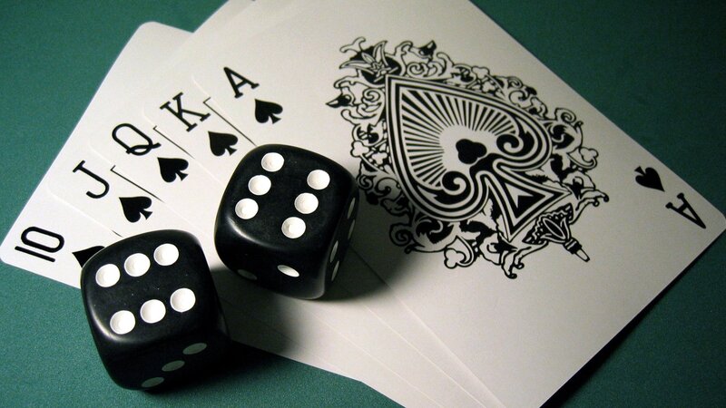 cards and dice on green felt