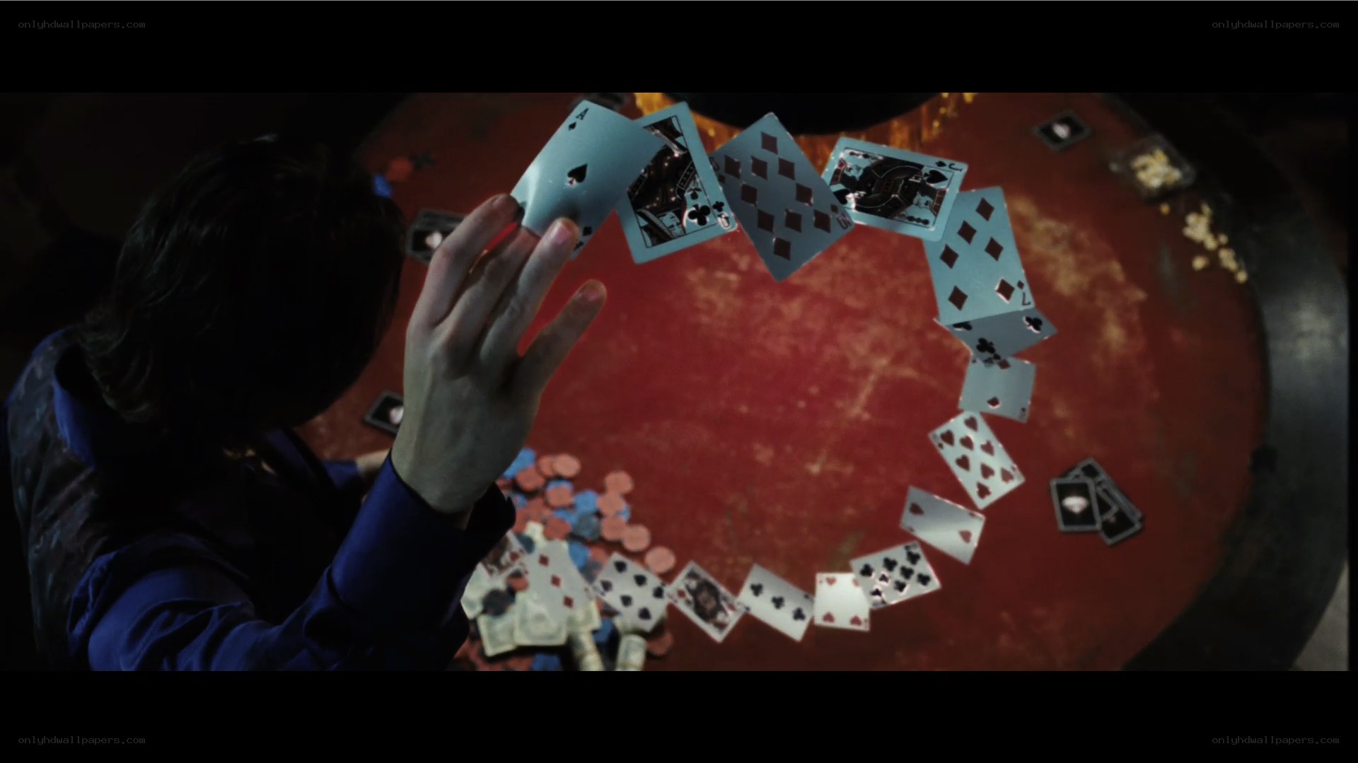 cards in mid-air at table