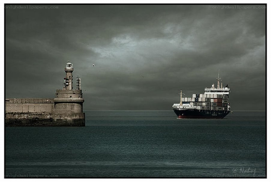 Cargo ship near lighthouse