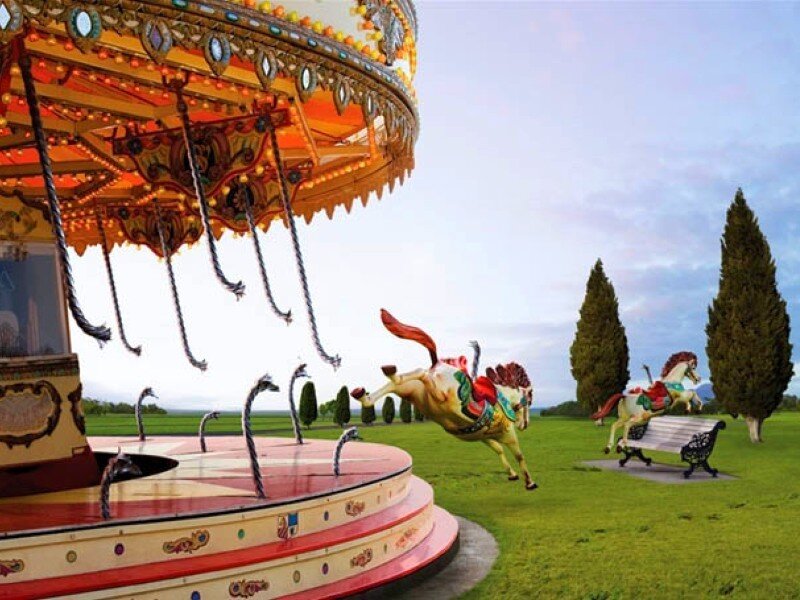Carousel horses in a field