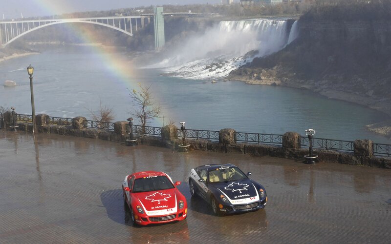 Cars at Niagara Falls with rainbow