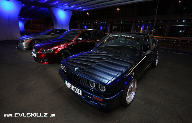 Cars at night under a bridge