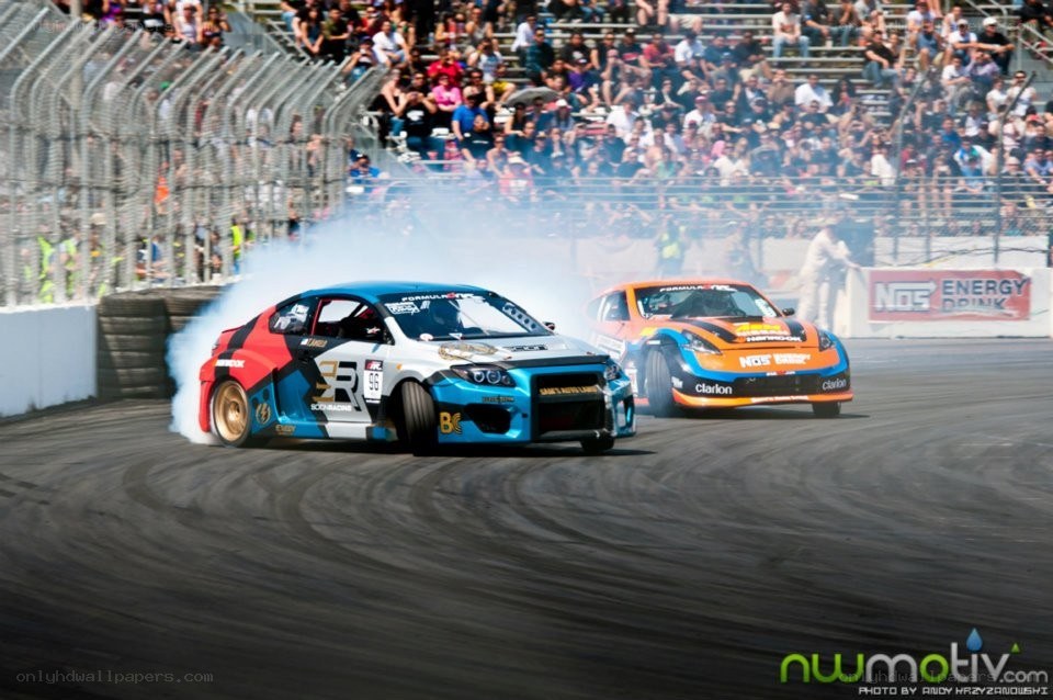 Cars drifting at a race
