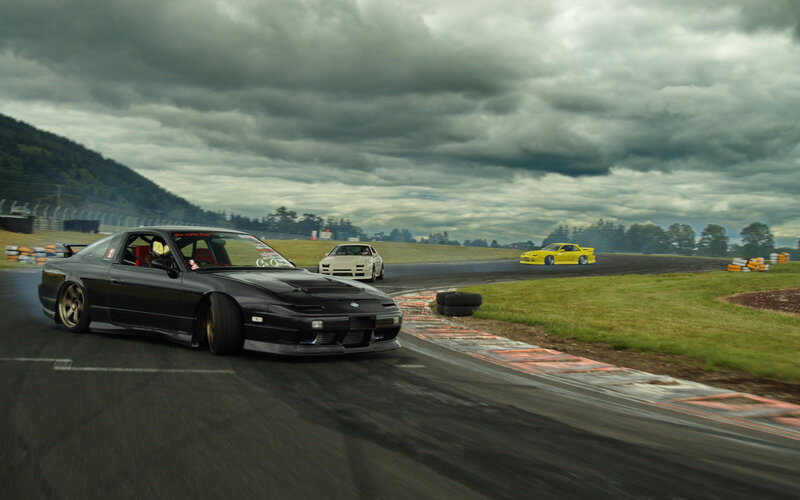Cars drifting on a racetrack