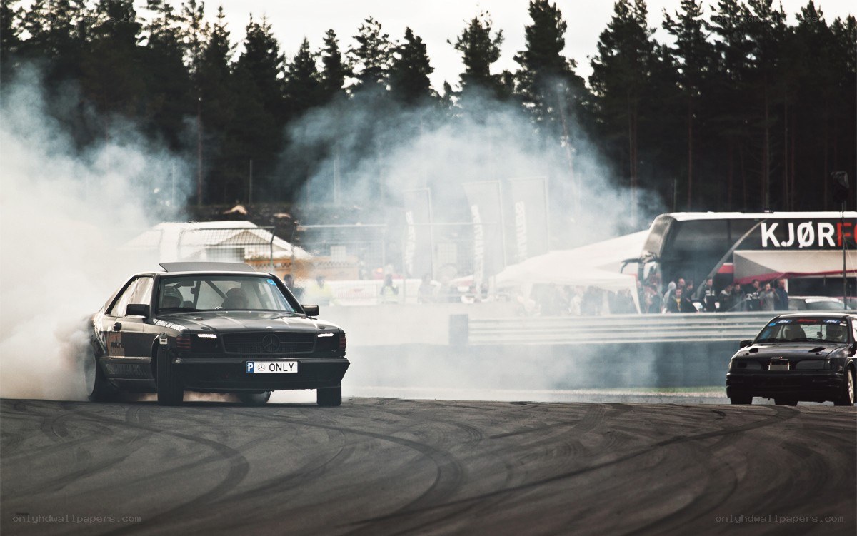 Cars drifting on a racetrack