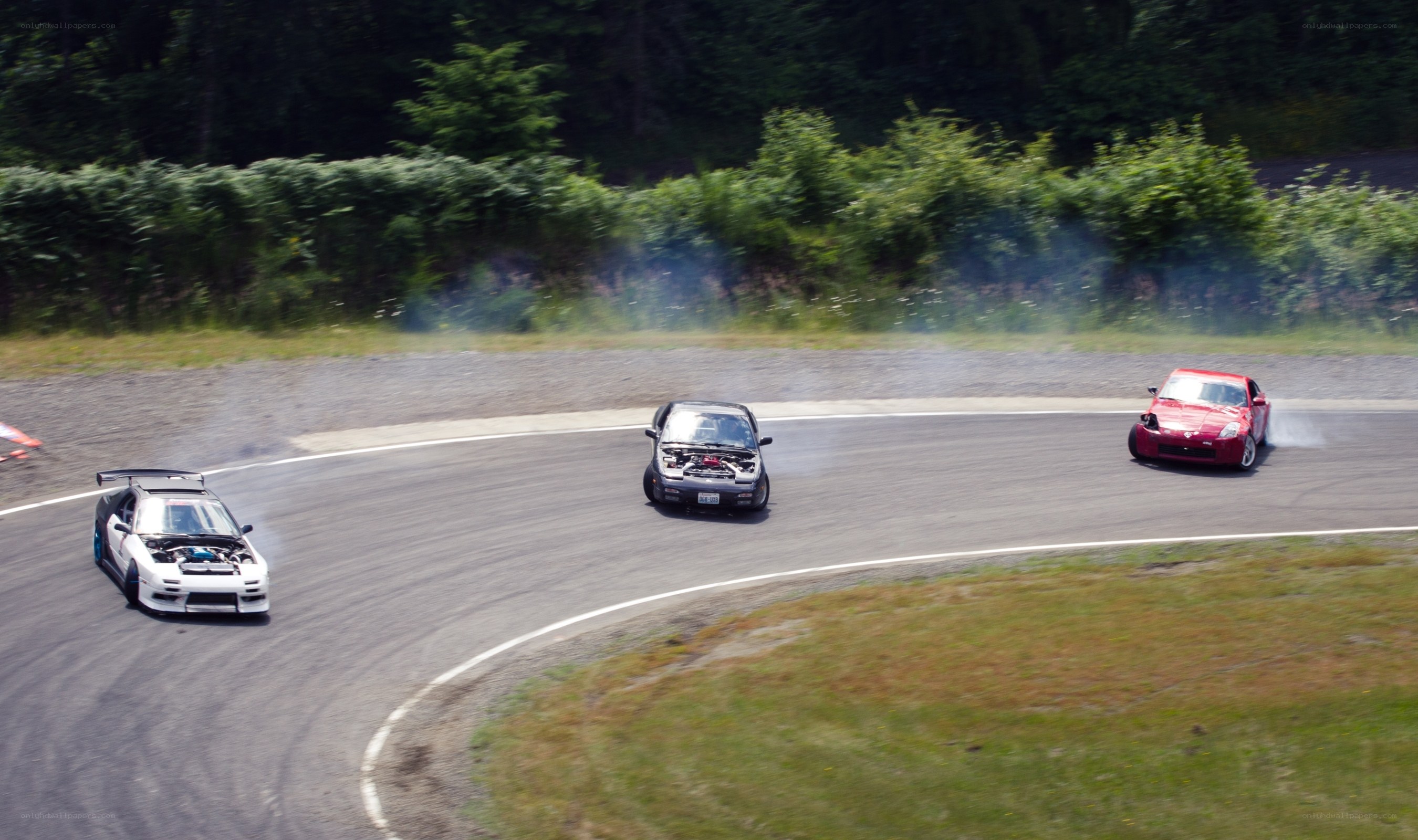Cars drifting on a racetrack