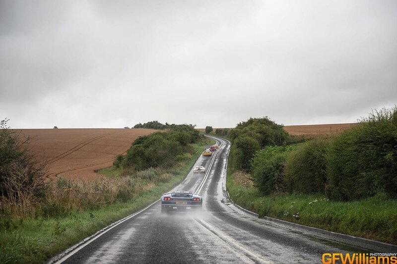 Cars driving on a wet country road
