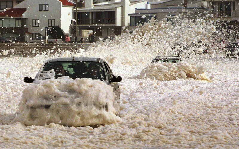 Cars flooded by sea foam