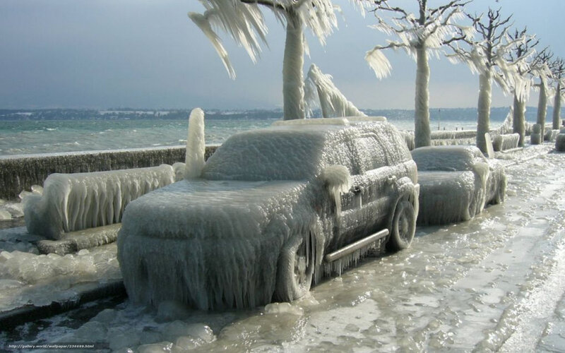 Cars frozen in ice by lake
