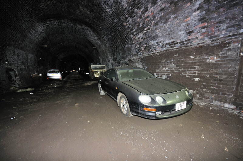 Cars in a brick tunnel