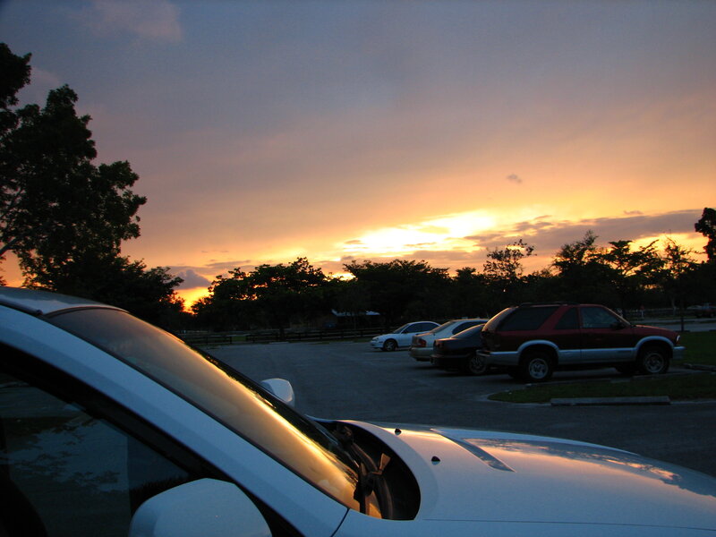 Cars in parking lot at sunset
