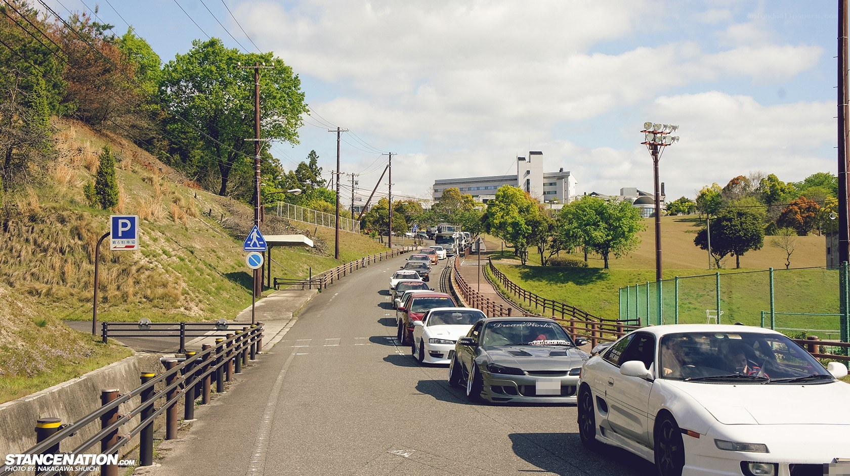 Cars lined up on a hillside road