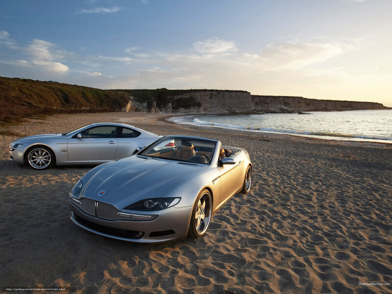 Cars on a beach at sunset