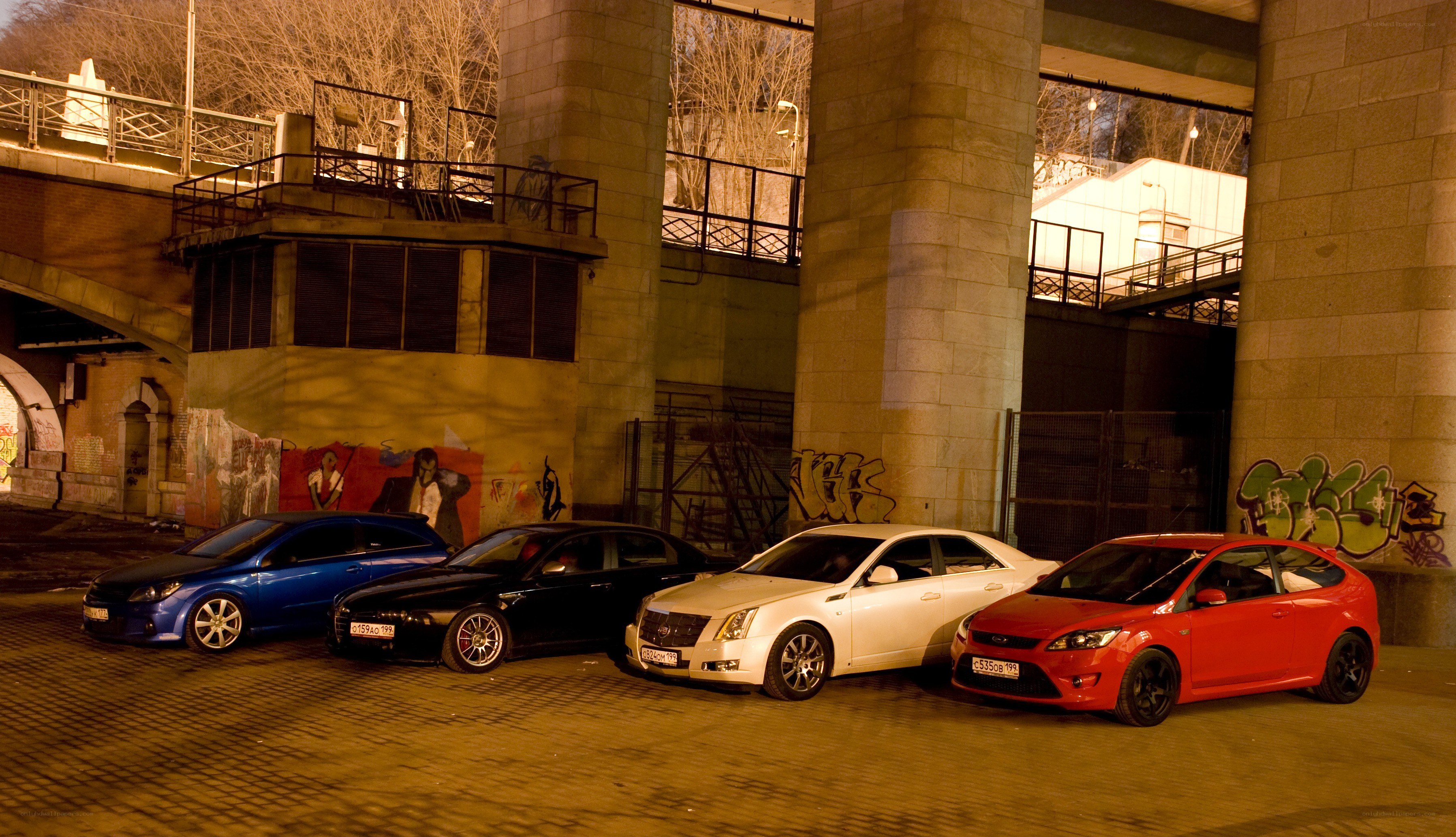 cars parked under a bridge
