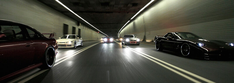 cars racing in a tunnel
