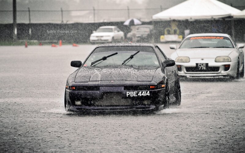 Cars racing in the rain