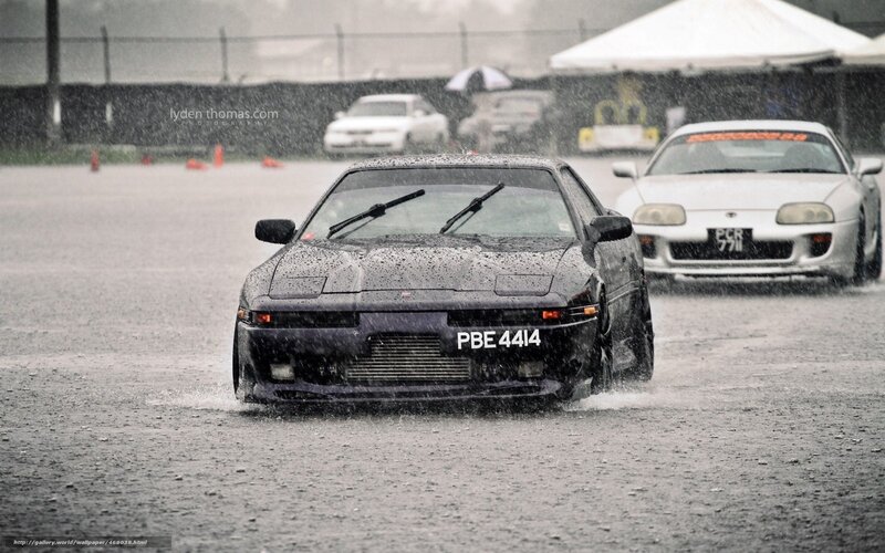 Cars racing in the rain