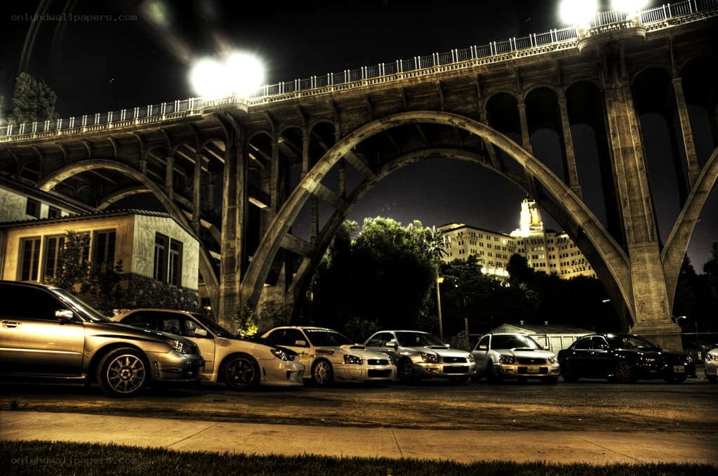 Cars under a bridge at night