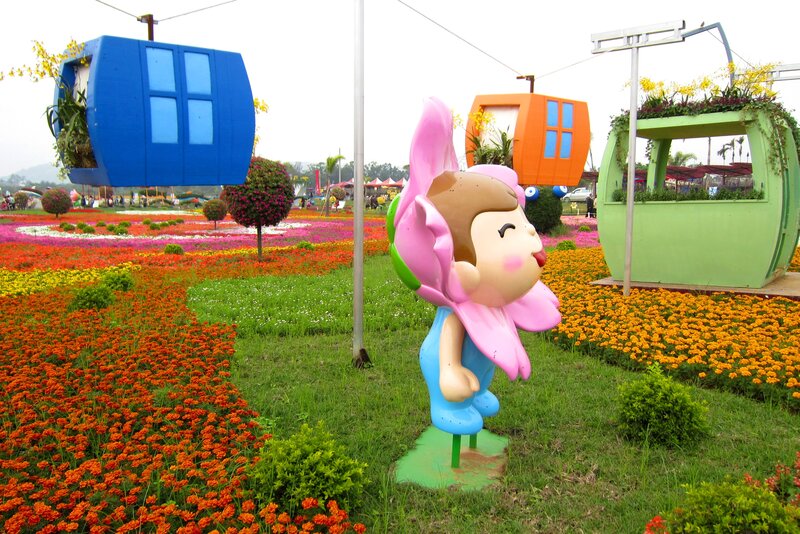 Cartoon Statue in Flower Garden