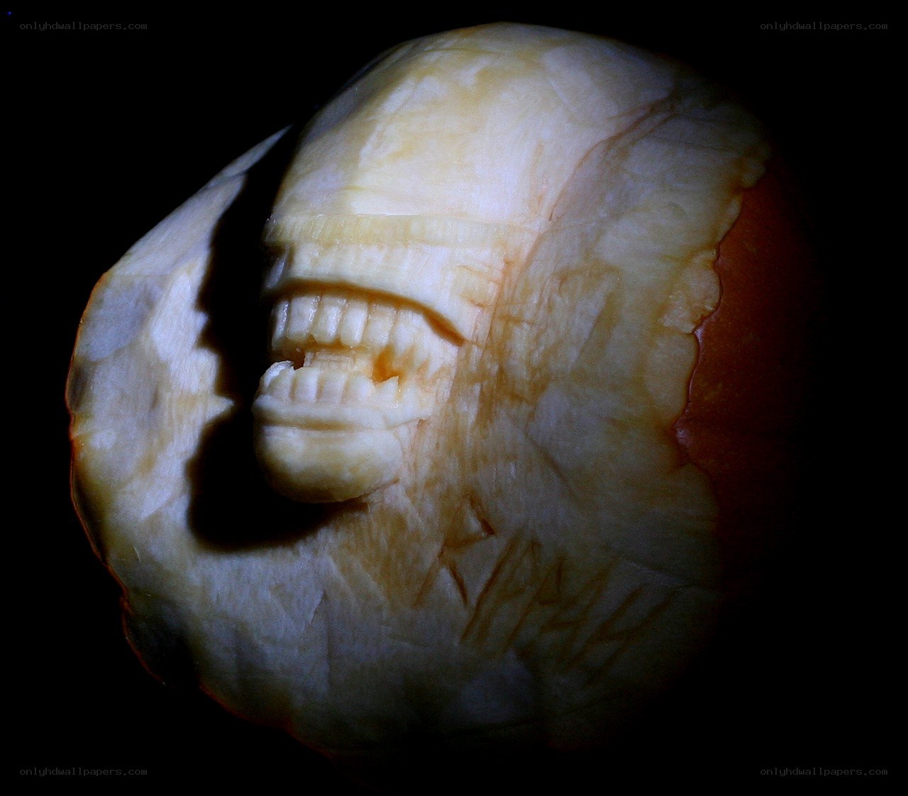 carved alien face from apple