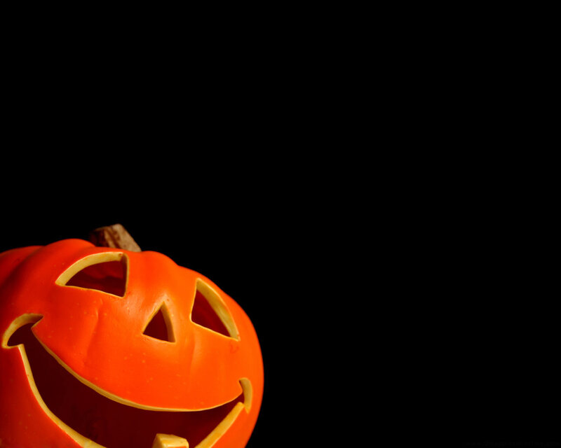 carved pumpkin on black