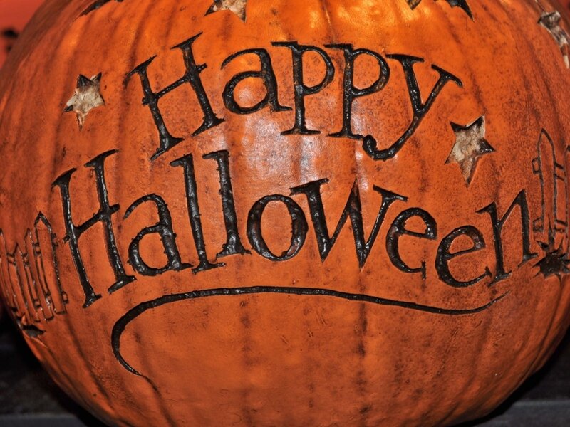 carved pumpkin with happy halloween