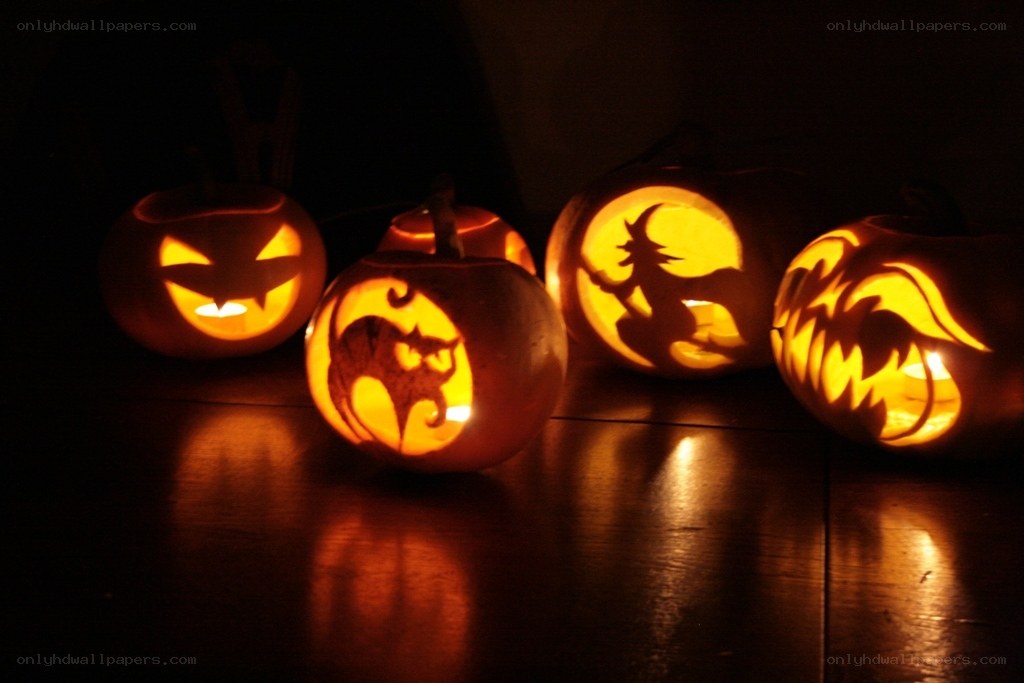 carved pumpkins at night