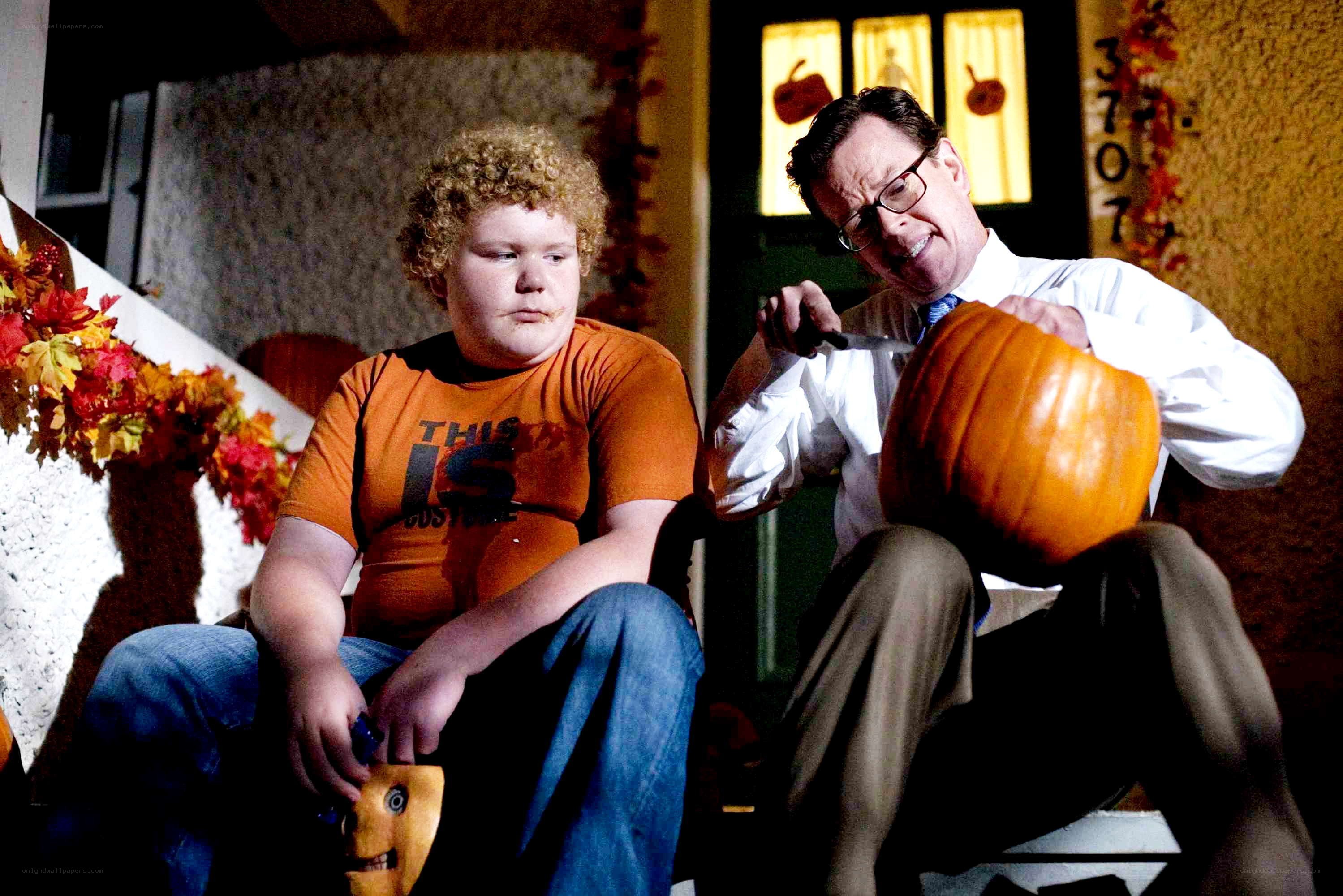 Carving pumpkins on a porch