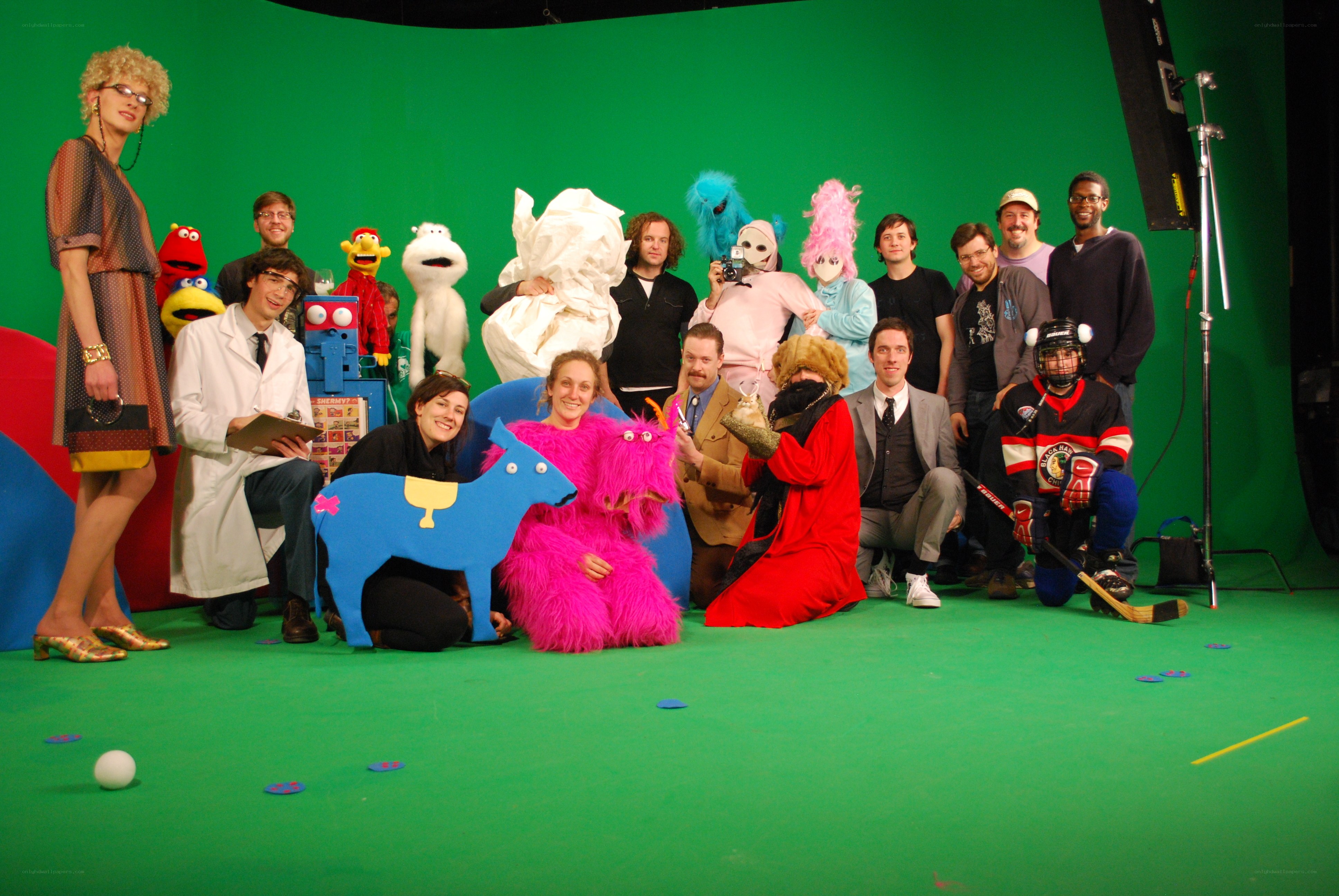 Cast and crew on green screen set