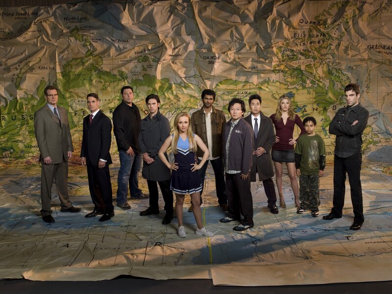 Cast in front of a world map