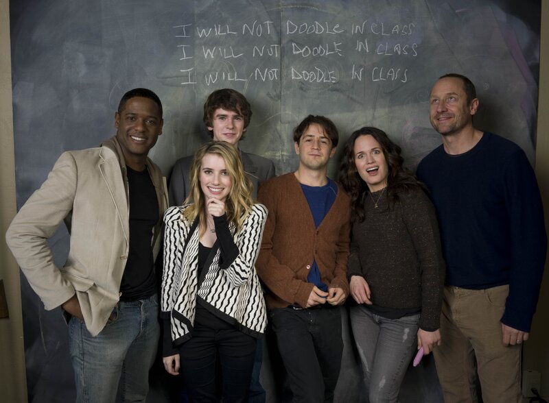 Cast in front of chalkboard