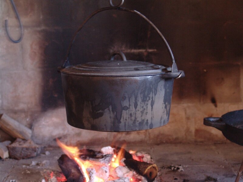 cast iron pot over fire