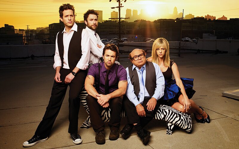 cast on a rooftop at sunset