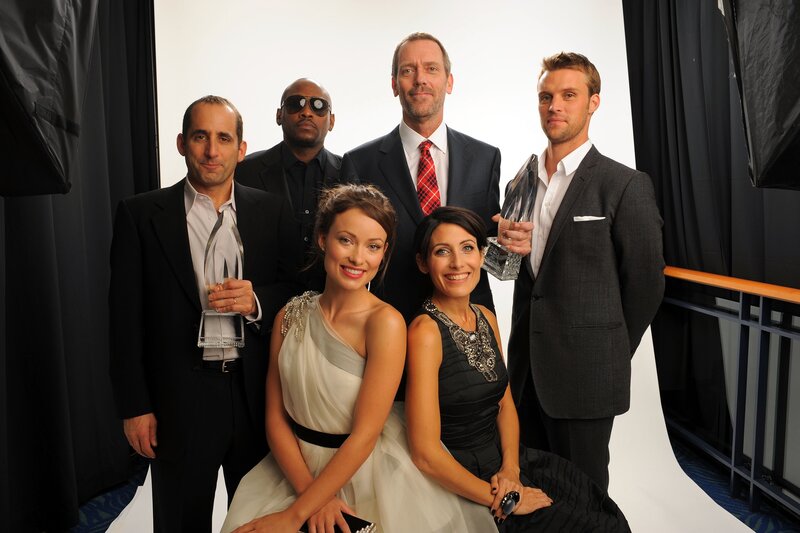 cast poses with awards