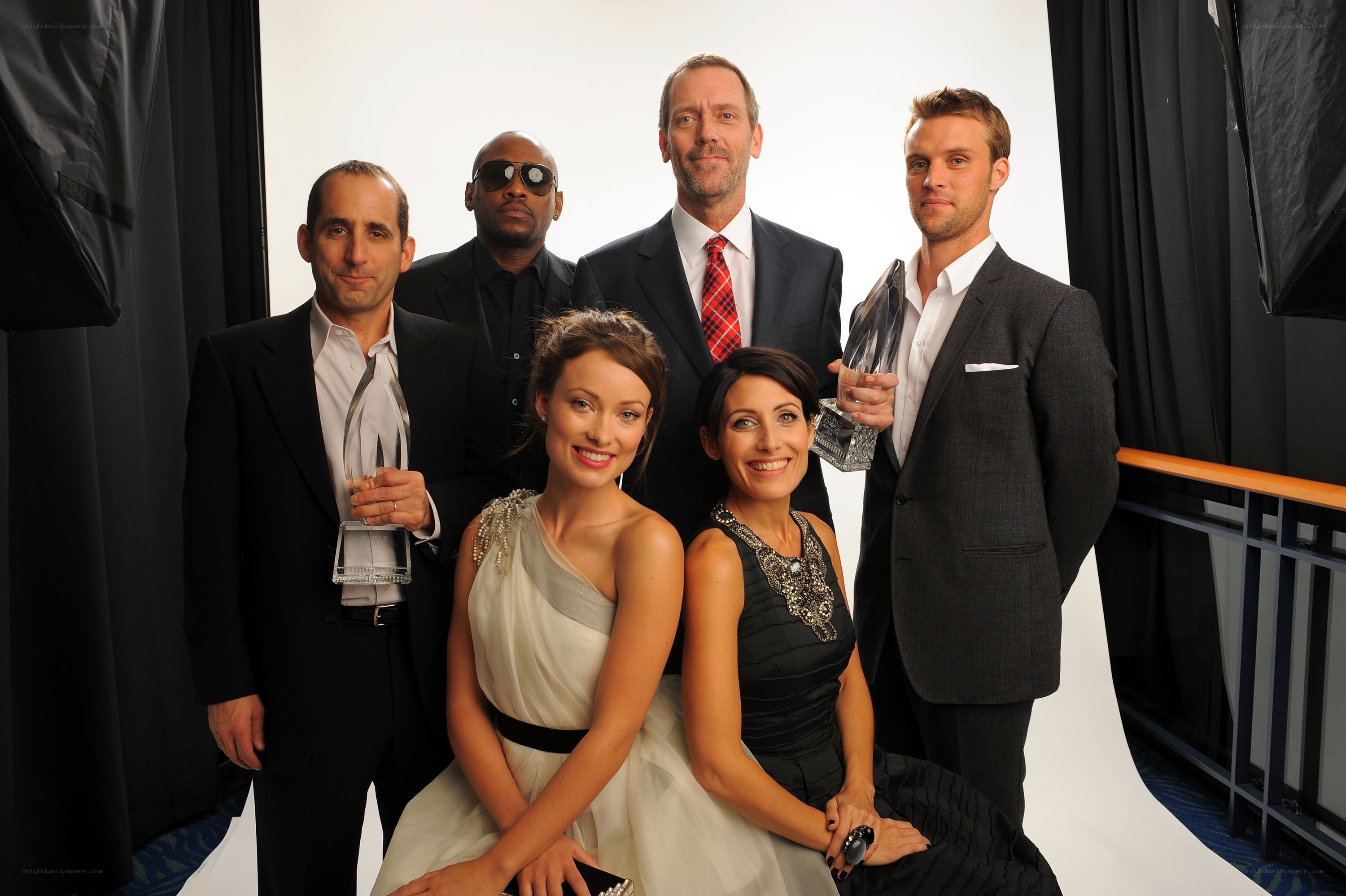 cast poses with awards