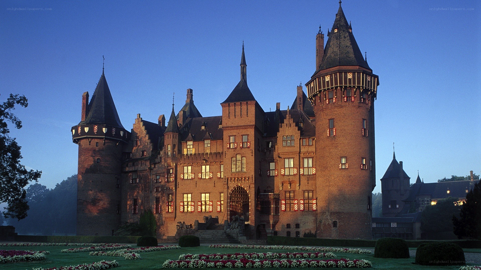 Castle at dusk with flower beds