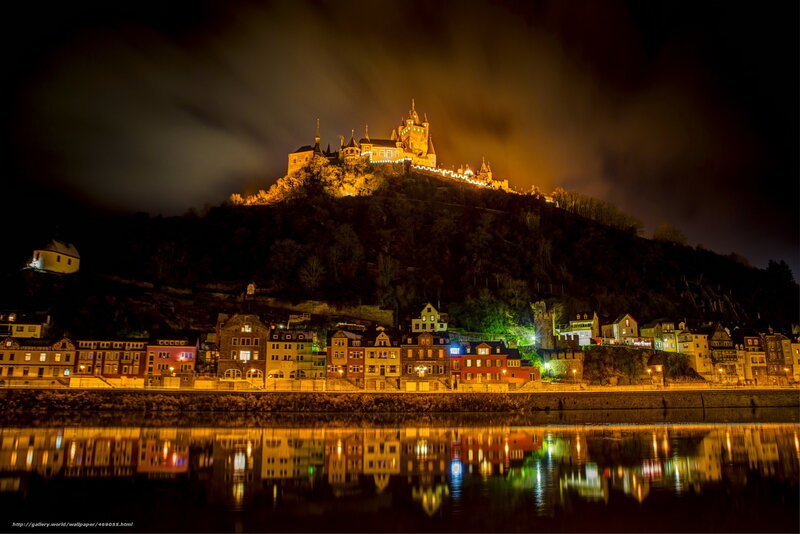 Castle at night with river reflection