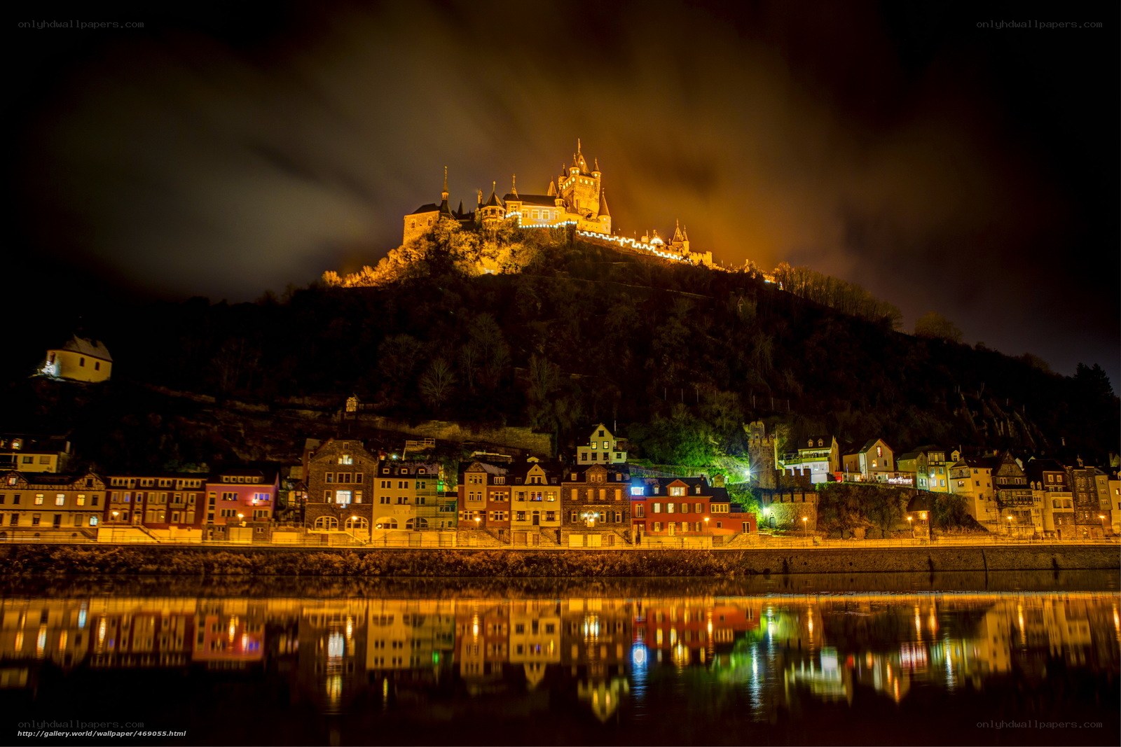 Castle at night with river reflection
