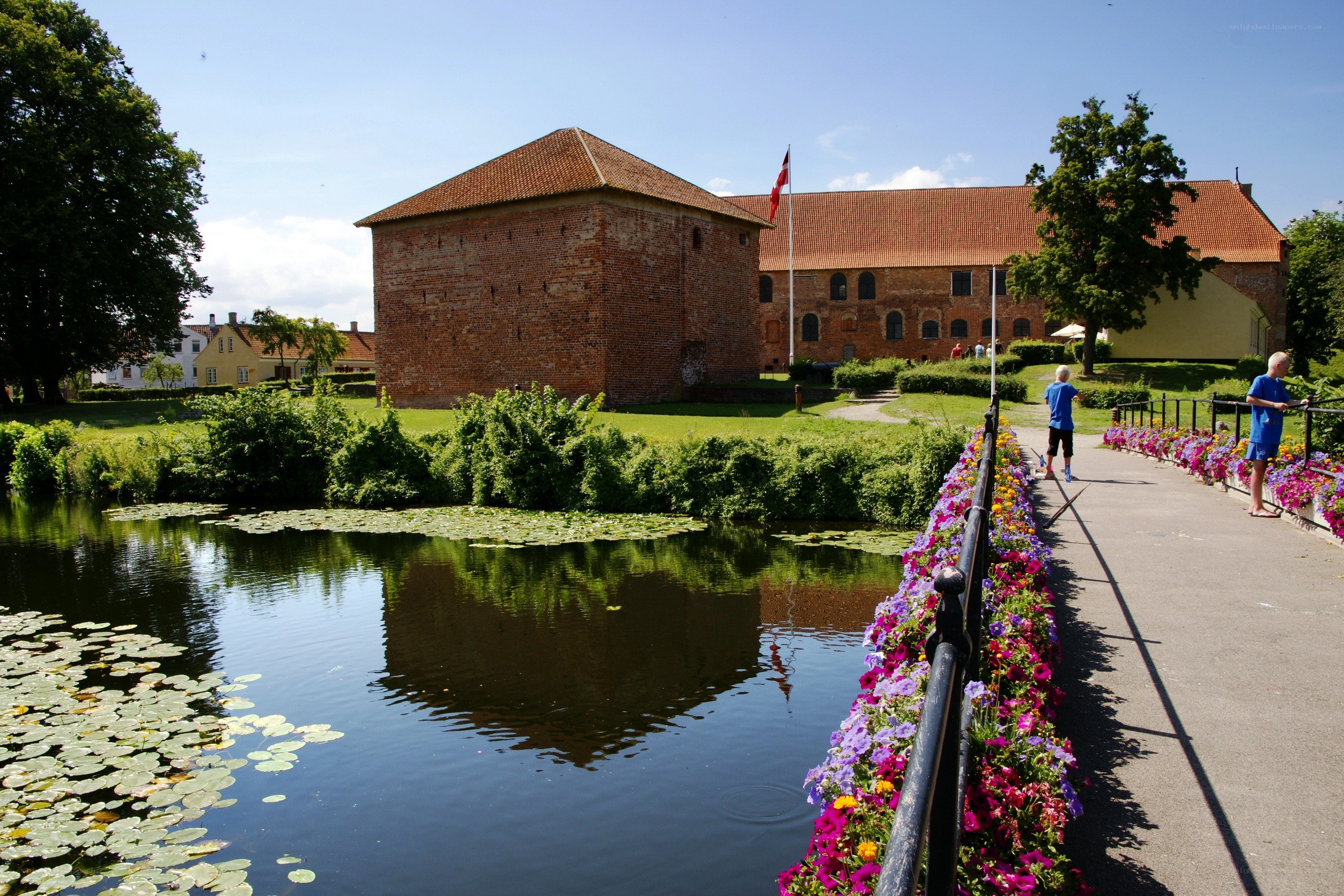 Castle by a flower-lined canal
