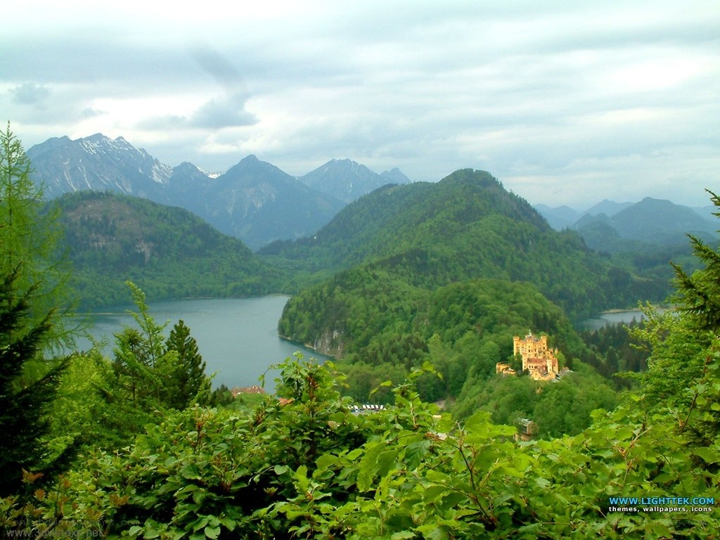 castle by a lake in mountains