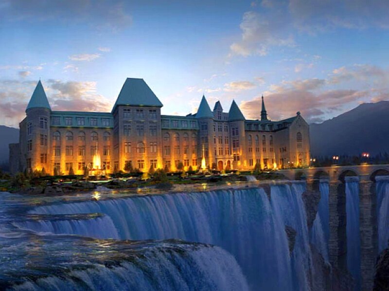 castle by a waterfall at dusk