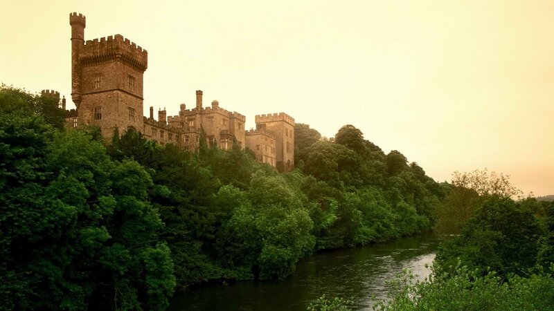 castle by the river at sunset