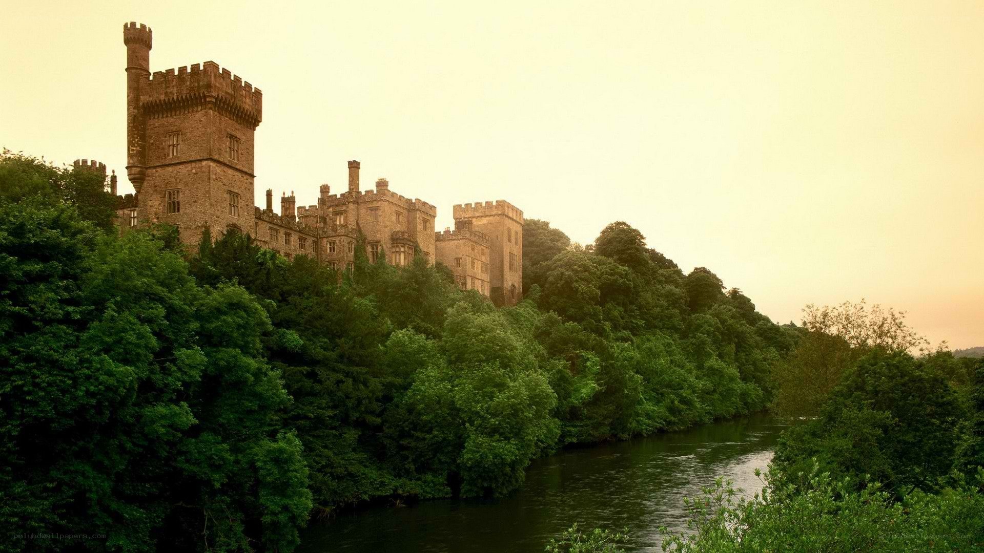 castle by the river at sunset