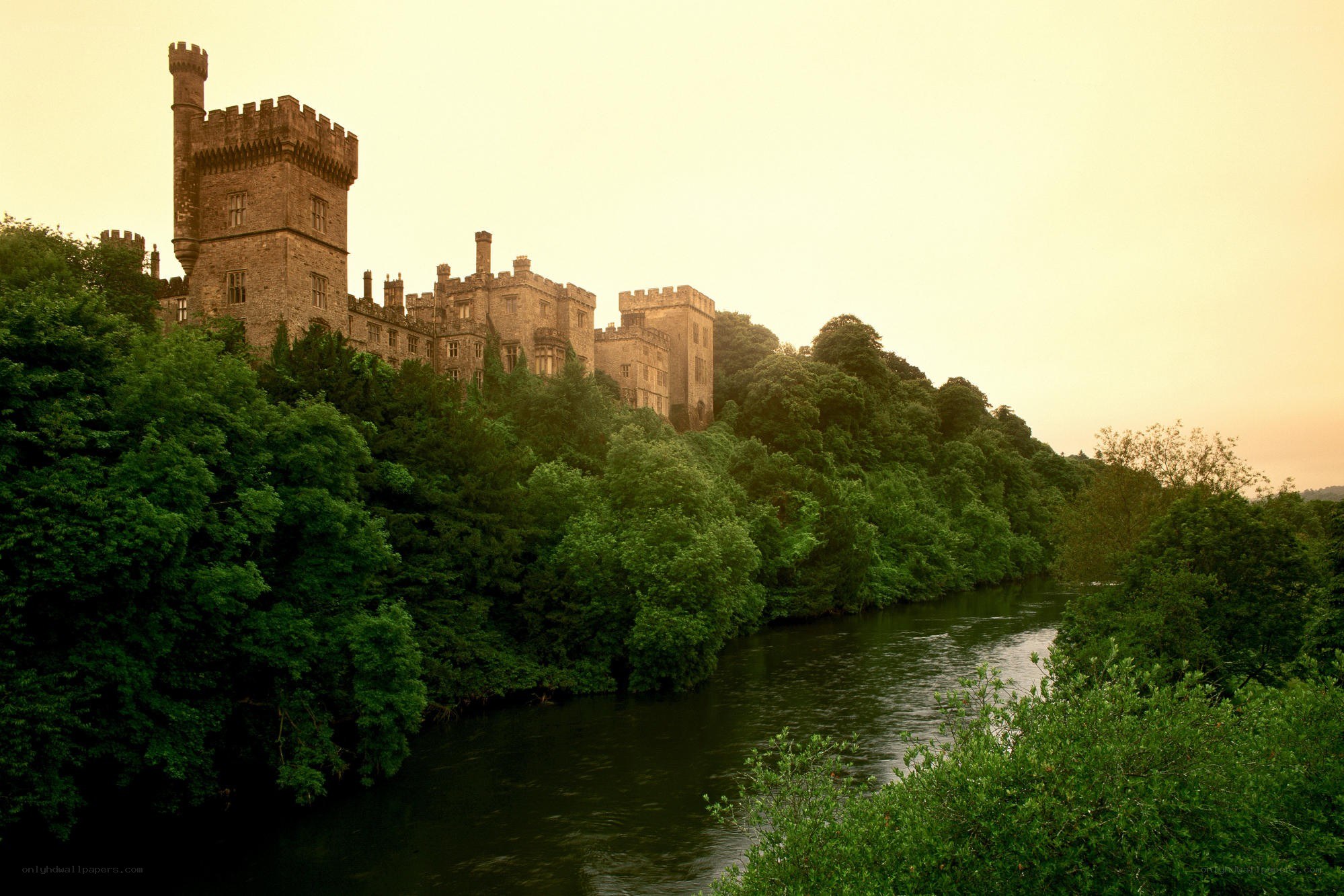 castle by the river at sunset
