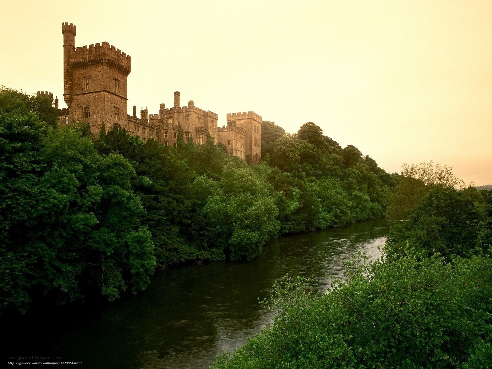 castle by the river at sunset