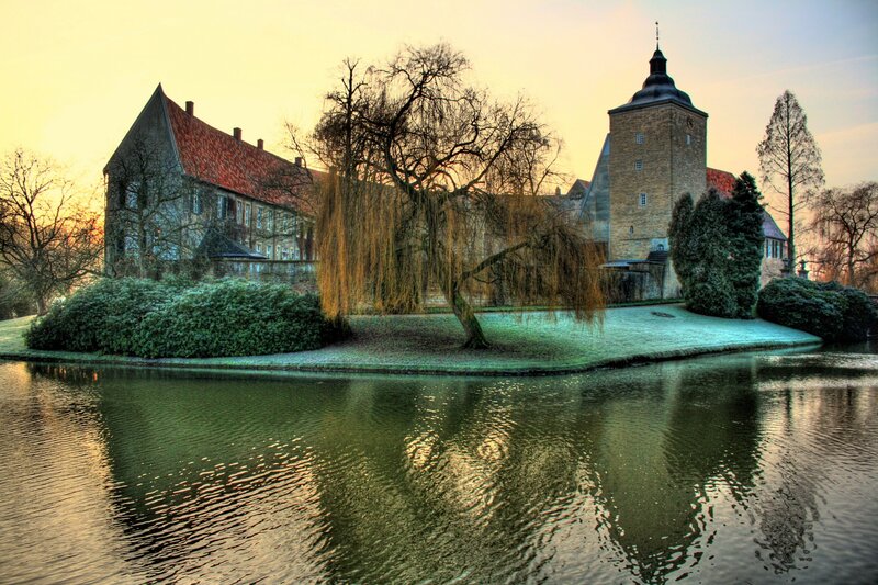 castle by the water at sunset
