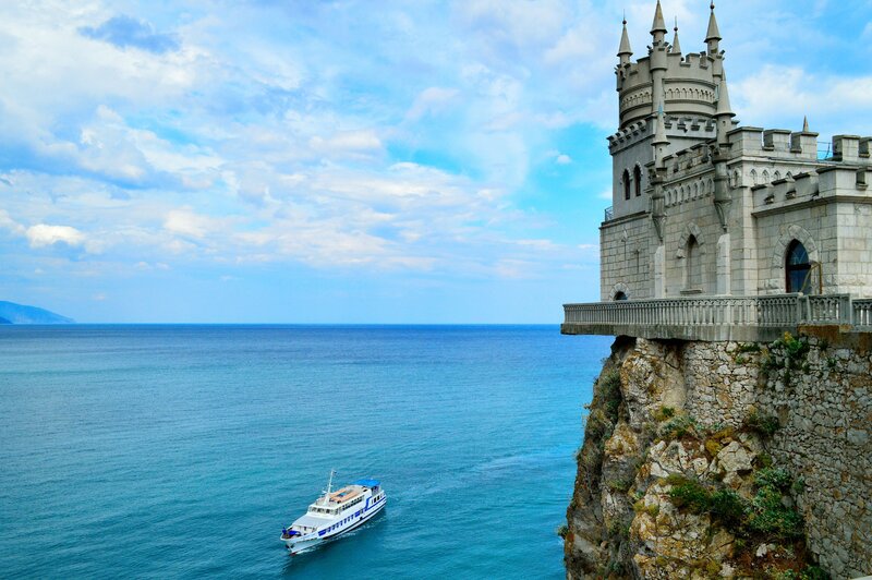 Castle on a Cliff — Blue, Serene, Afternoon, Photograph, Boat