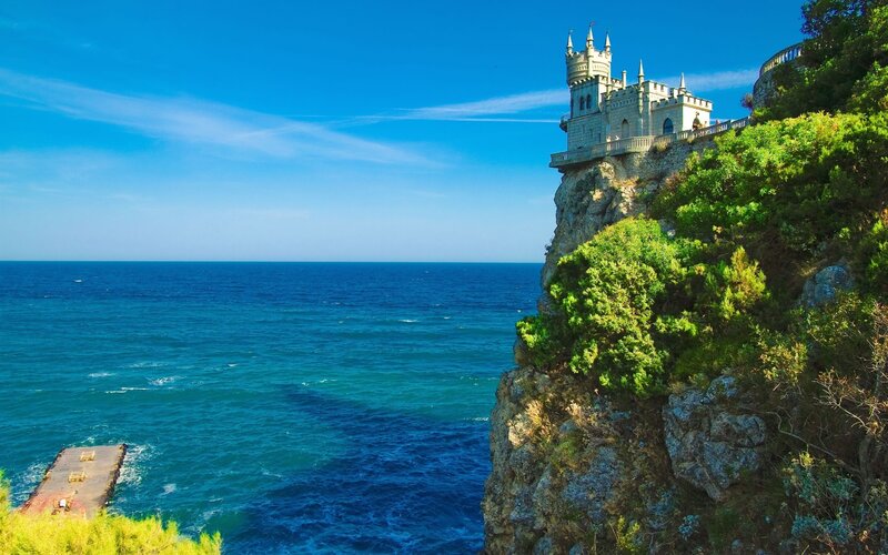 Castle on a Cliff — Blue, Serene, Afternoon, Photograph, Ocean, Trees, Pier